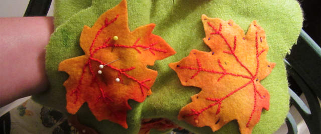 pinning autumn leaves in place for blanket stitch