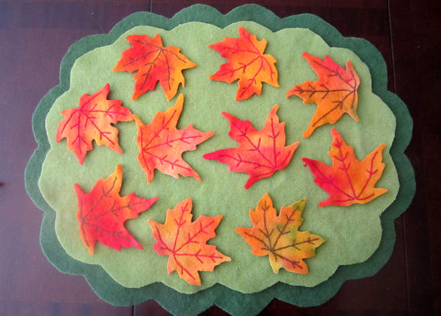 autumn leaves scattered on recycled wool blanket